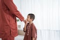 Asian boy kissing his father`s hand when celebrating Happy Eid Ul- Royalty Free Stock Photo