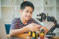 Asian boy learning and studying the work of technology robots.homeschool and science for tech project. playing childhood kids