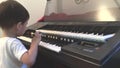 Asian boy learning to play electone