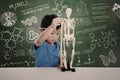 Asian kid measuring human skeleton model Royalty Free Stock Photo