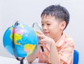 Asian boy looking at a globe Royalty Free Stock Photo