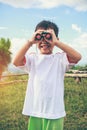 Asian boy looking through a telescope. Child relaxing holiday. V Royalty Free Stock Photo