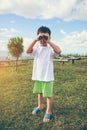 Asian boy looking through a telescope. Child relaxing holiday. V Royalty Free Stock Photo