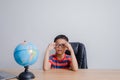Asian boy looking at world map Royalty Free Stock Photo