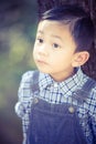 Asian boy lookingup outdoors