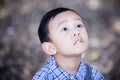 Asian boy lookingup outdoors