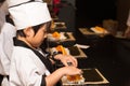 Asian boy making sushi