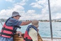 Asian boy and older man, his grandfather, trip on pleasure boat on sea. Royalty Free Stock Photo