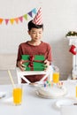 Asian boy in party cap holding Royalty Free Stock Photo