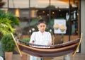 Asian boy play the ranat ek Thai musical xylophone instrument in the percussion