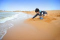 Asian boy playing on the beach Royalty Free Stock Photo