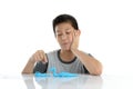 Asian boy playing blue clay on white