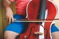 Asian boy playing a classical instrument cello at his house