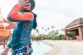 Boy playing next to a water slide in aqua water park Royalty Free Stock Photo