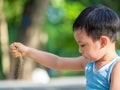 An asian boy playing outdoor activity with excited on something new Royalty Free Stock Photo