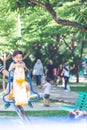 An Asian boy is playing a rocking horse in an outdoor playground Royalty Free Stock Photo