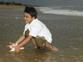 Asian boy playing in the sea water Royalty Free Stock Photo