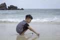 Asian boy playing toy on a sea beach Royalty Free Stock Photo