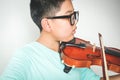 An Asian boy is playing the violin. Royalty Free Stock Photo