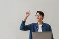 Asian boy pointing finger upward working with laptop Royalty Free Stock Photo