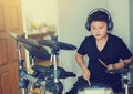 Asian boy put black tshirt and headphone learning and play elect