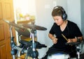 Asian boy put black tshirt and headphone learning and play elect