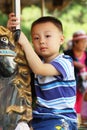 Asian boy is ridding horse