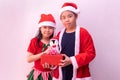 Asian boy in santa clothes and girl in Elf clothes holding gift. Merry christmas Royalty Free Stock Photo