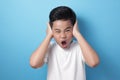 Asian boy screaming and close his ears, don& x27;t want to hear Royalty Free Stock Photo