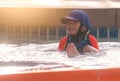 Boy siiting next to a water slide in aqua water park