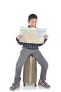 Asian boy sitting on lugguage and holding map on white Royalty Free Stock Photo