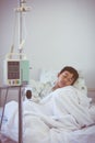 Asian boy sleeping on sickbed with infusion pump intravenous IV