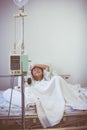 Asian boy sleeping on sickbed with infusion pump intravenous IV