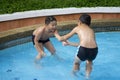 Asian boy smile in swimming pool Royalty Free Stock Photo