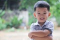 Asian boy smiling happily and standing with his hands crossed Royalty Free Stock Photo