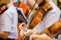 Asian boy students playing violin with music notation in the group. Violin player. Violinist hands playing violin orchestra