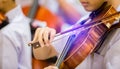 Asian boy students playing violin with music notation in the group. Violin player. Violinist hands playing violin orchestra