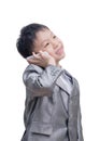 Asian boy in suit talking on mobile phone over white background Royalty Free Stock Photo