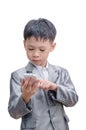 Asian boy in suit using mobile phone Royalty Free Stock Photo