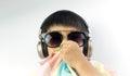 Asian boy with sunglasses is listening to music Royalty Free Stock Photo