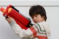 Asian boy with a toy gun Royalty Free Stock Photo