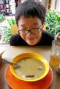 Asian boy trying street food