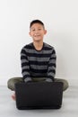 Asian boy using laptop at home Royalty Free Stock Photo