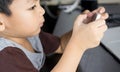 Asian boy is using smartphone to play games Royalty Free Stock Photo