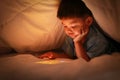 Asian boy using tablet for internet learning. Royalty Free Stock Photo