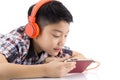 Asian boy ware headphone and playing the cell phone Royalty Free Stock Photo