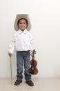 Asian boy wearing a cowboy hat holding a violin Royalty Free Stock Photo