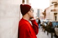 Asian boy wearing eyeglasses talking on mobile phone by wall Royalty Free Stock Photo