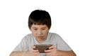 Asian boy wearing headphones playing a games on smart phone Royalty Free Stock Photo