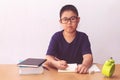 Asian boy writeing a book on table Royalty Free Stock Photo